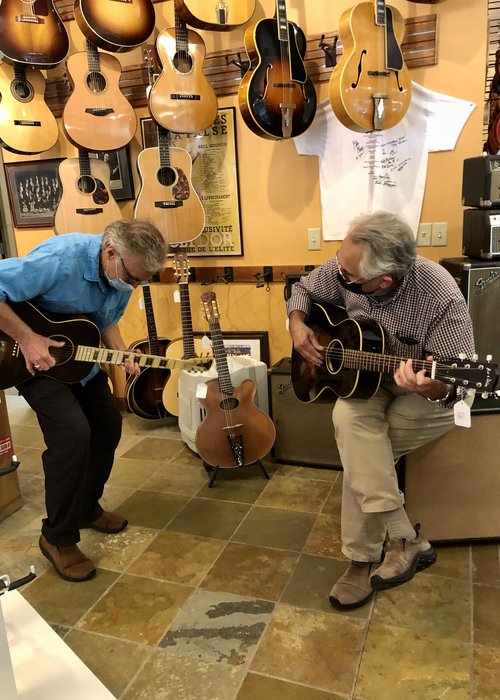 These two guys show up and play some old guitars.