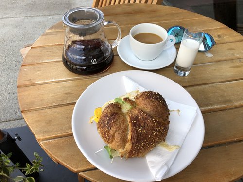 A Brazilian "pour over" and fried egg sandwich with micro greens and cheddar on a homemade seeded...
