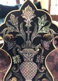 Close up of the peghead on the Unger Banjo showing the detailed hand engraving of the mother of p...