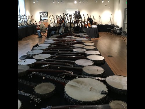 Table full of Stewart banjos assembled for a great presentation by Joe and Norm.