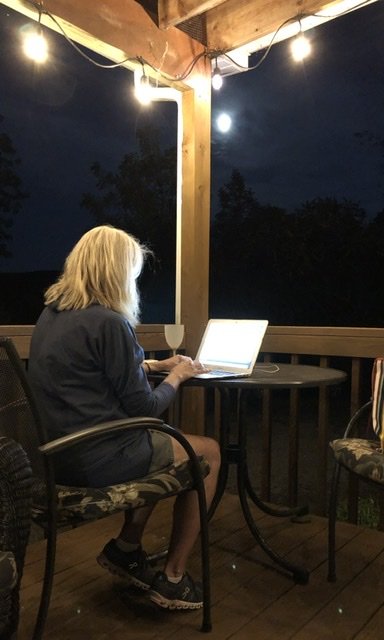 Julie working late Sunday night at the lake. Actually she is proofreading my newsletter!