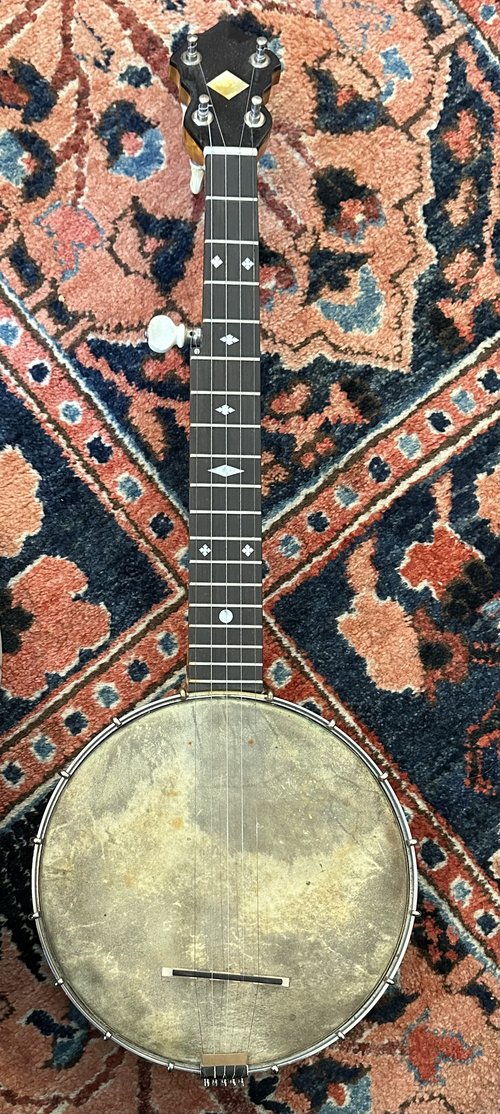 About the only instrument in playing condition was this little banjo with an old, Wm. Cole&nbsp;r...