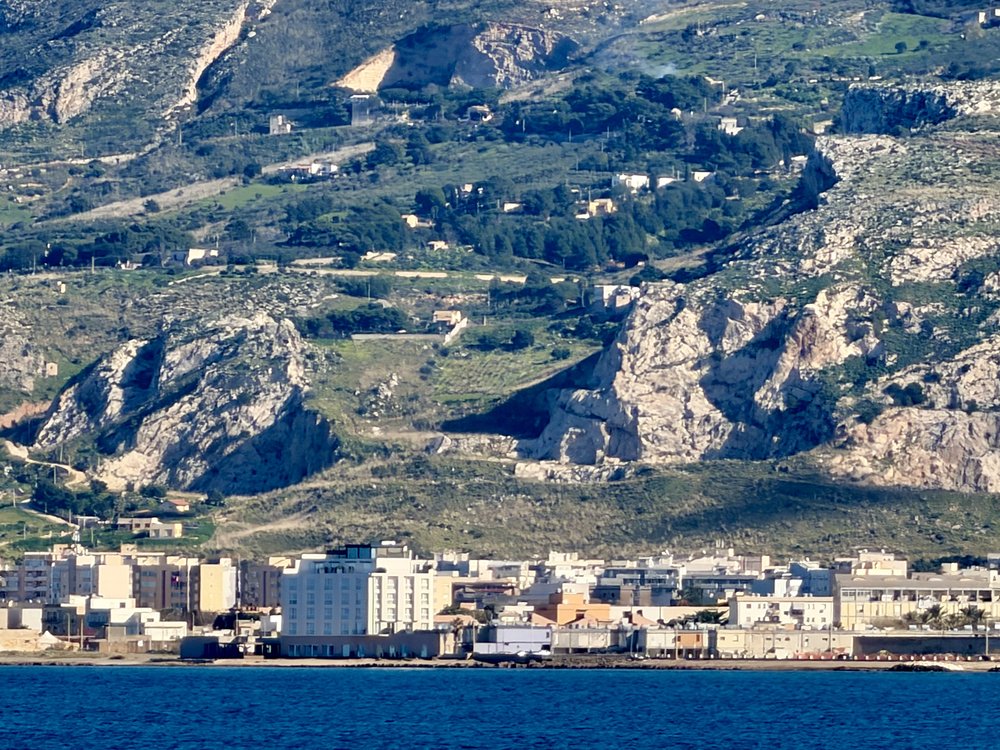 A town of the sea with a mountain hovering over it