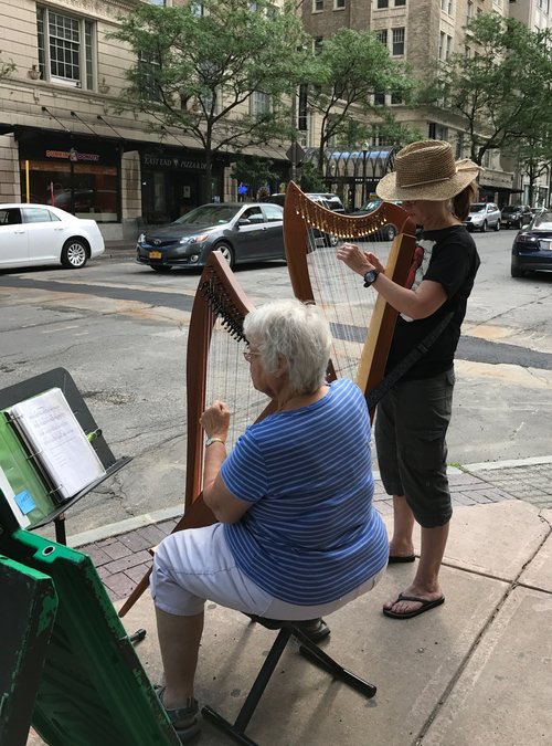 Harpists take over the corner of East and Swan.