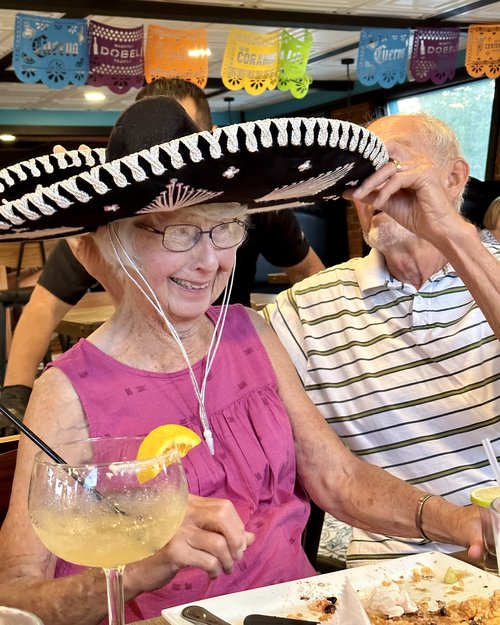 Barbara Schnepf let’s her husband Henry get her sombrero straight before her shot of tequila!!