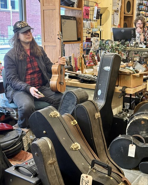 Sam Snyder with a pile of vintage cases. In the background is Alex Côté our latest new employee&h...