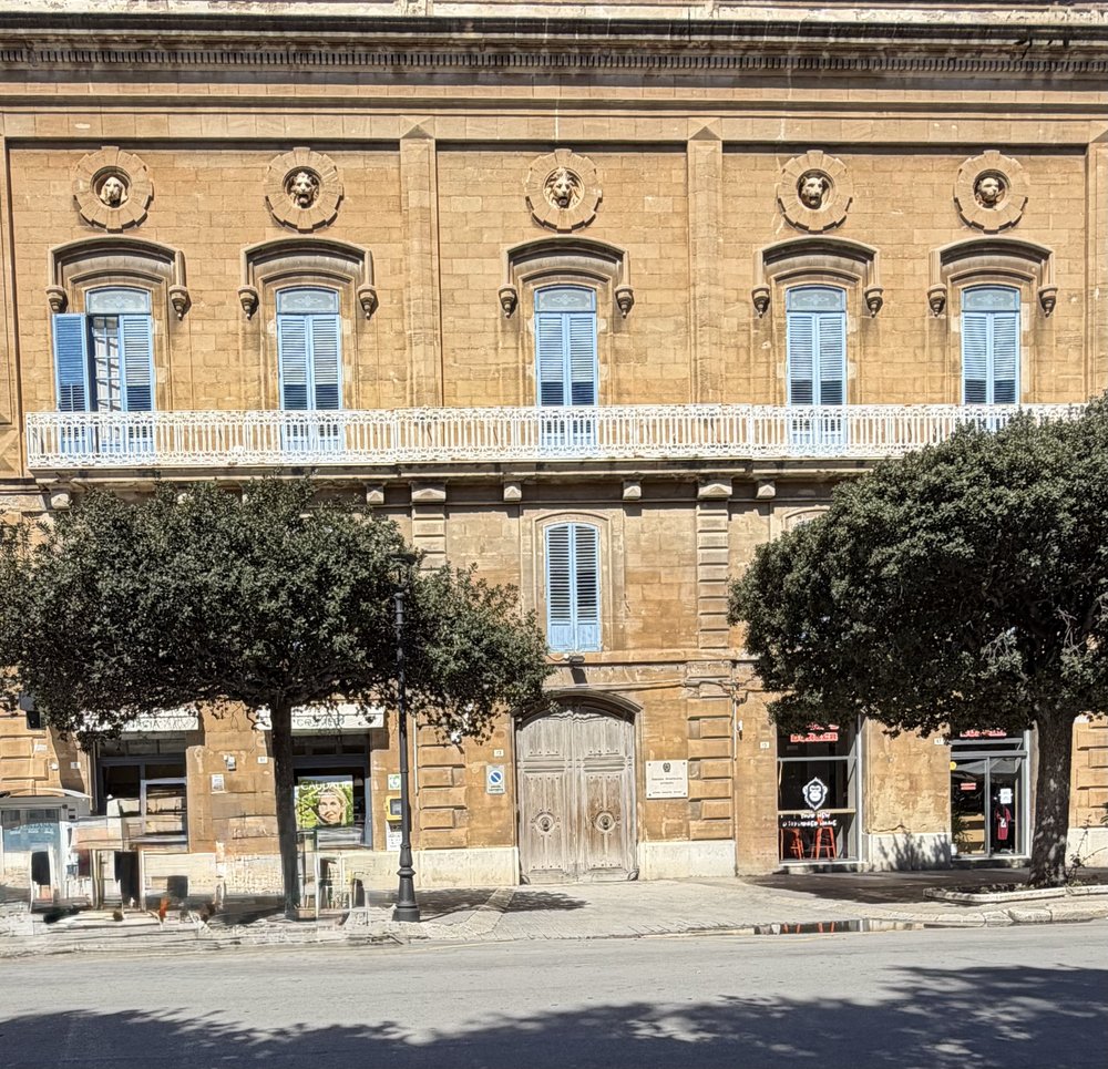 This large building on the north side of the Villa Margherita Park has five animal heads carved a...