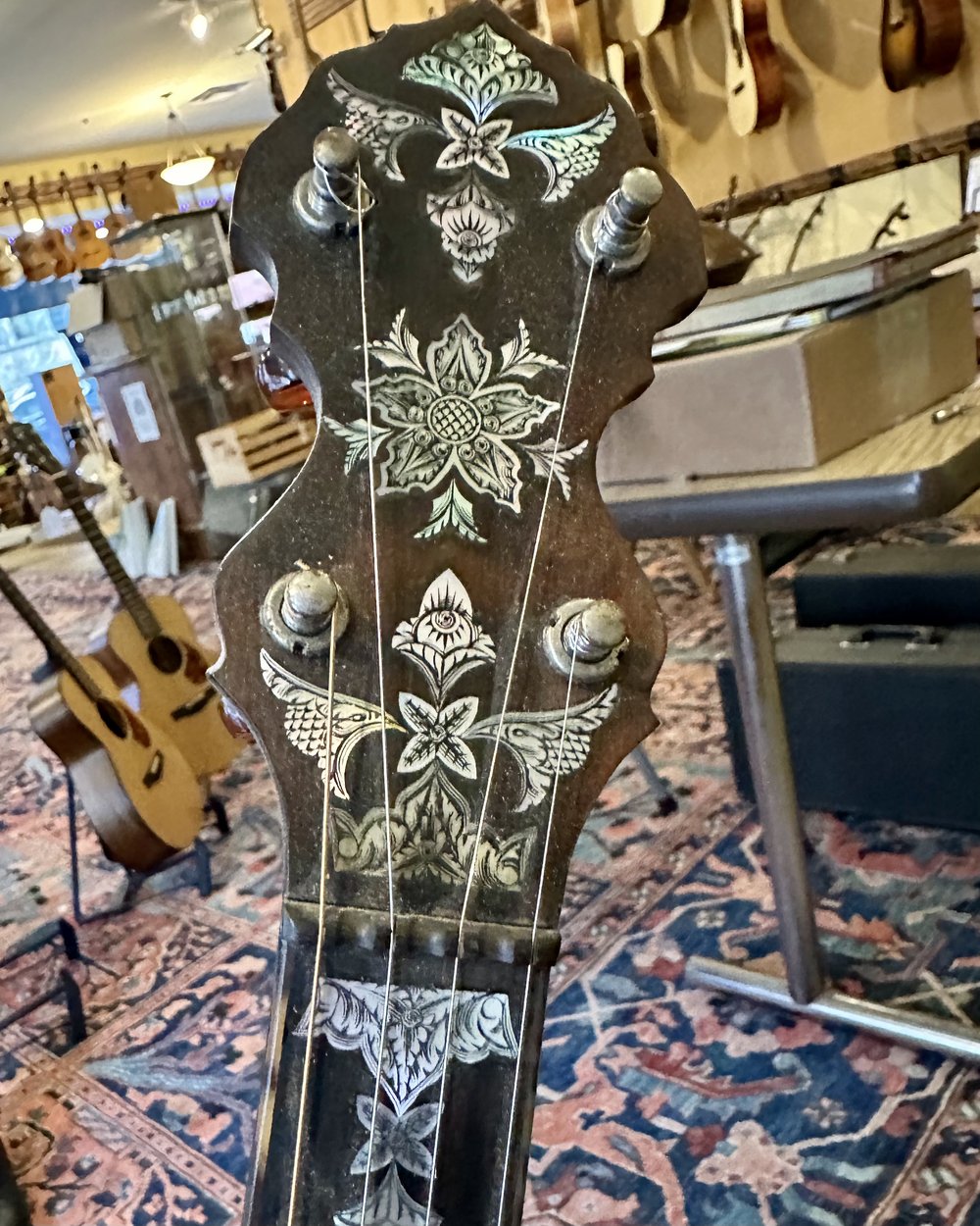 The peghead of the latest Unger banjo. His engraving is the best there has ever been.