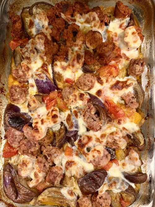 A wonderful eggplant casserole with homemade sausage, tomatoes, onions, pesto, and fresh mozzarel...