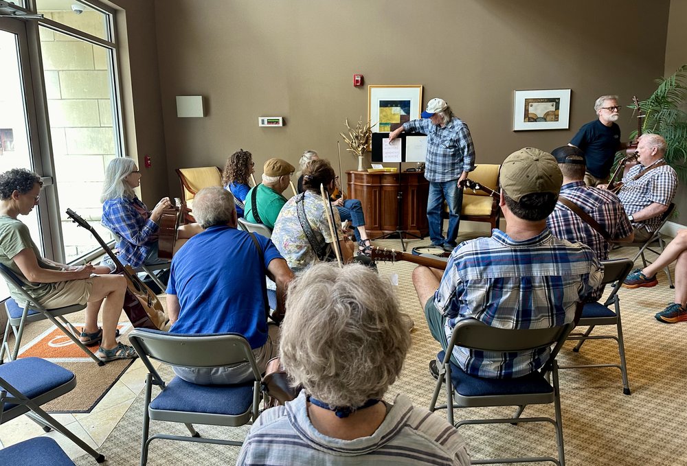 Dan Palmer has evolved into a professor of old-time Banjo. Here is holding class in the back room...